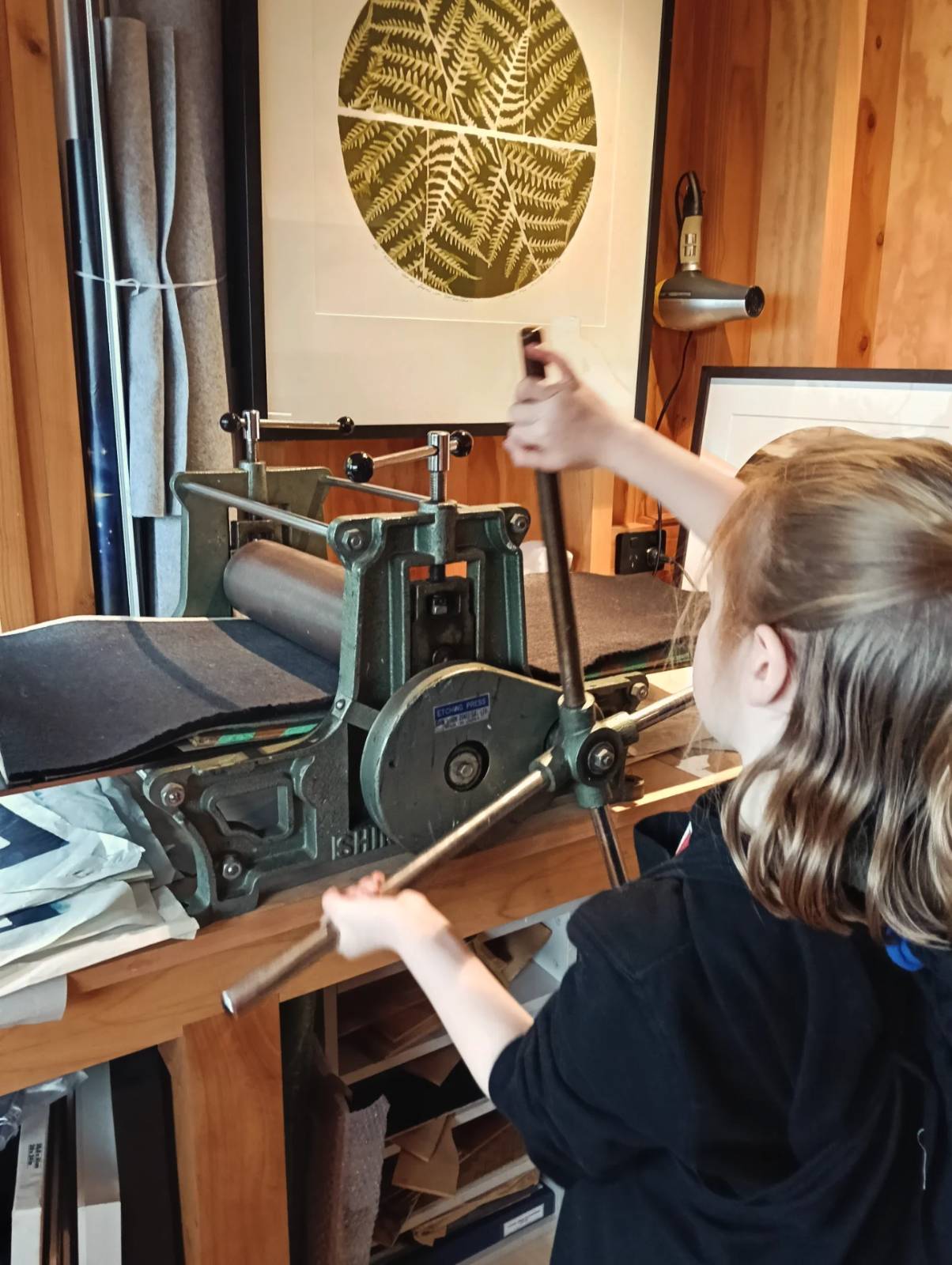 A girl using the printing press